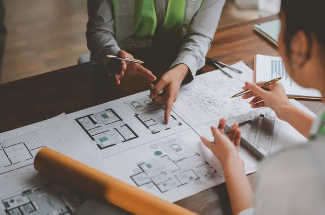 Architects discussing blueprints